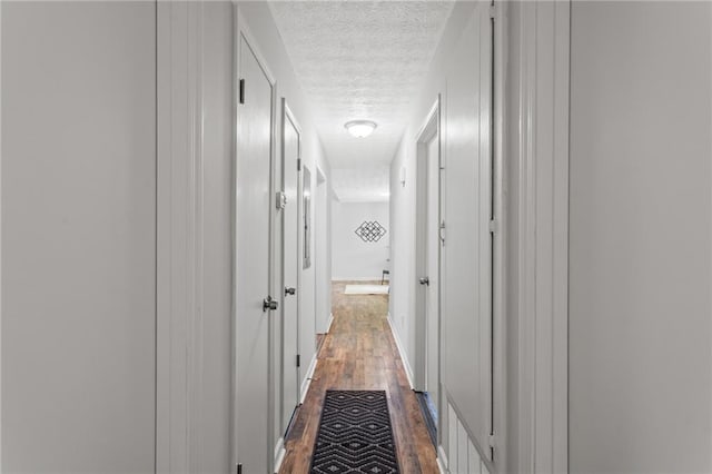 3833 Paddington Trl, Rex, GA 30273 - hall featuring a textured ceiling and dark wood-style floors