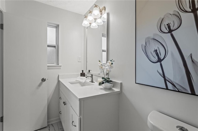 3833 Paddington Trl, Rex, GA 30273 - half bathroom featuring vanity, marble finish floors, and a textured ceiling