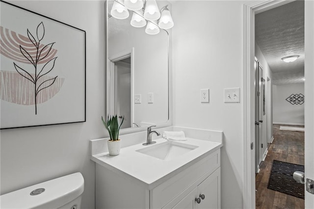 3833 Paddington Trl, Rex, GA 30273 - bathroom with wood finished floors, vanity, and a textured ceiling