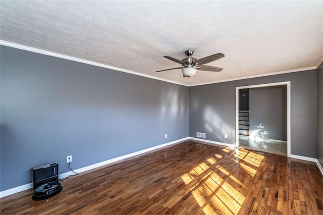 unfurnished room with ceiling fan, dark wood-type flooring, and ornamental molding