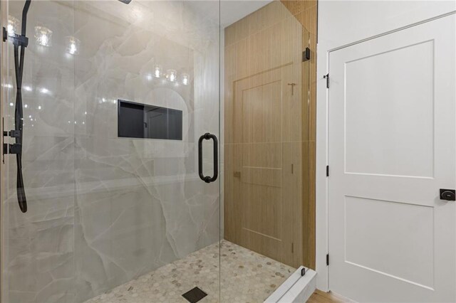 6371 Falcon Ln, Gainesville, GA 30506 - bathroom featuring double vanity, a sink, a stall shower, and wood finished floors