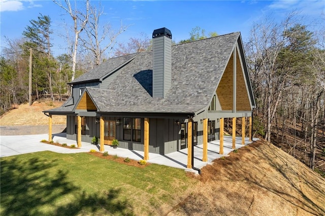 6371 Falcon Ln, Gainesville, GA 30506 - view of front of property with board and batten siding, a front lawn, french doors, and roof with shingles