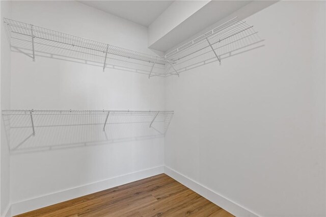6371 Falcon Ln, Gainesville, GA 30506 - bathroom featuring a marble finish shower, baseboards, and wood finished floors