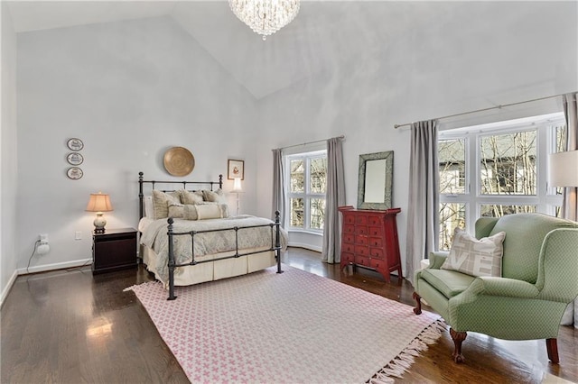 bedroom featuring dark hardwood / wood-style floors, a notable chandelier, and high vaulted ceiling