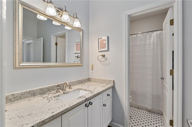 bathroom featuring vanity and curtained shower