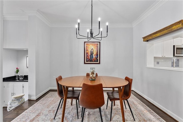 dining area with an inviting chandelier, ornamental molding, and dark hardwood / wood-style floors