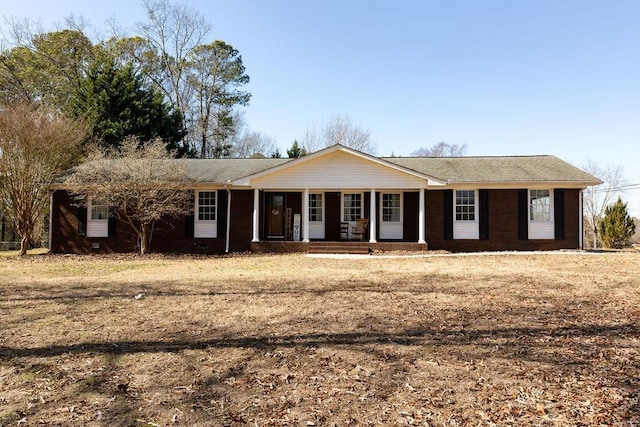 single story home with a porch and a front yard