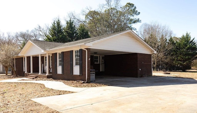 view of home's exterior featuring a carport and covered porch