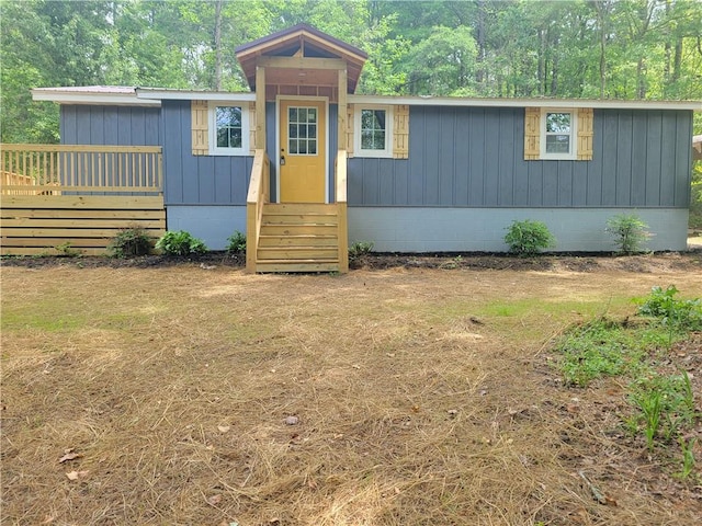 view of front facade featuring crawl space and board and batten siding