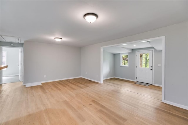 interior space featuring baseboards and light wood-style floors