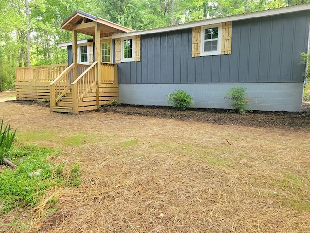 view of front of house with a deck, crawl space, and board and batten siding