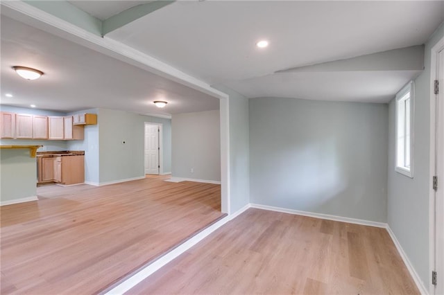 unfurnished living room with baseboards, recessed lighting, and light wood finished floors