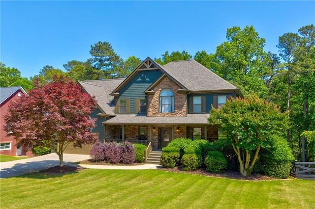 4418 Shellie Ln, Oakwood, GA 30566 - view of front of house featuring a porch, concrete driveway, a front lawn, stone siding, and a shingled roof