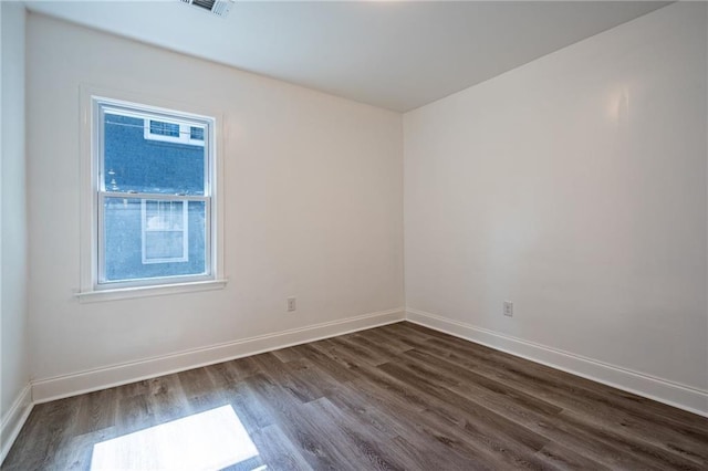 unfurnished room featuring dark hardwood / wood-style flooring