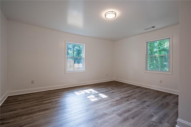 unfurnished room featuring dark hardwood / wood-style flooring