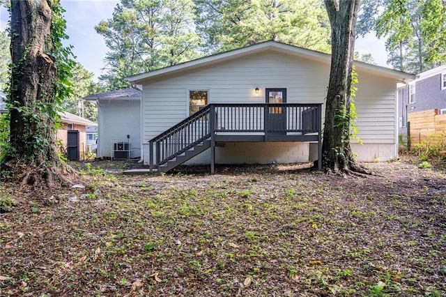 back of house with a wooden deck and cooling unit