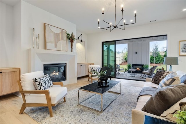 living room with hardwood / wood-style floors and a notable chandelier