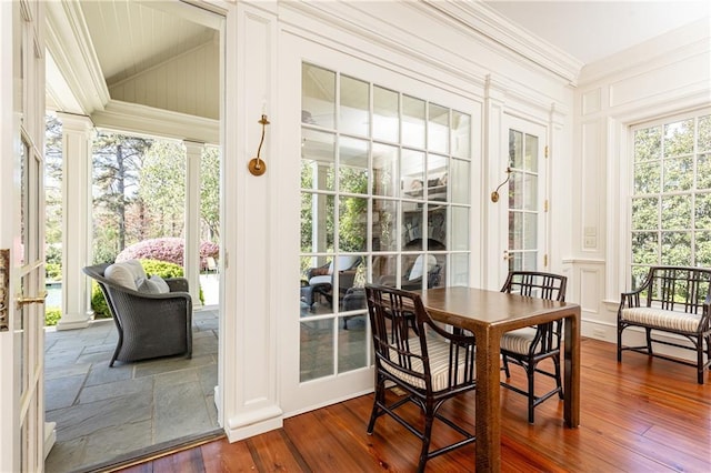 sunroom / solarium featuring decorative columns