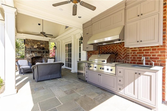 view of patio featuring area for grilling, ceiling fan, a stone fireplace, a sink, and a grill