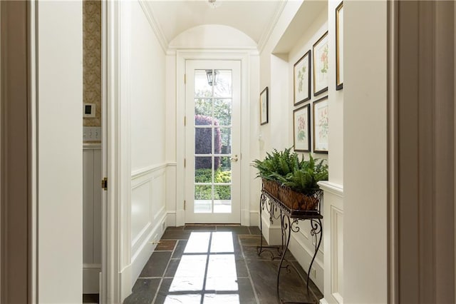 doorway featuring a decorative wall and wainscoting