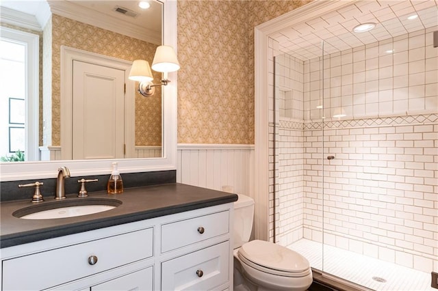 full bathroom with ornamental molding, wallpapered walls, a shower stall, wainscoting, and vanity