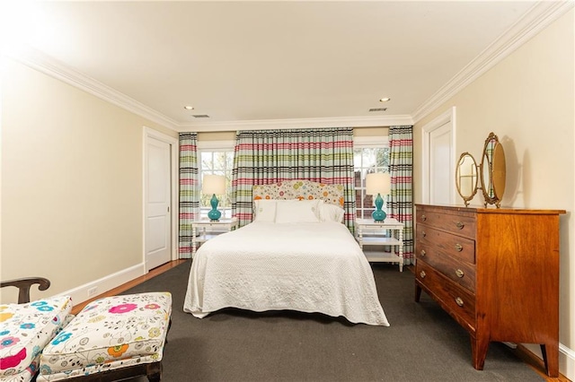 carpeted bedroom with visible vents, baseboards, and ornamental molding