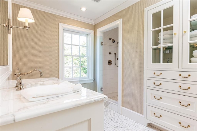 bathroom with vanity, a stall shower, and crown molding