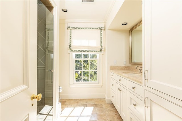 full bath with vanity, visible vents, baseboards, stone finish floor, and crown molding