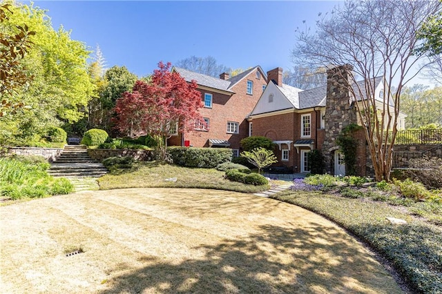 exterior space featuring brick siding and a chimney