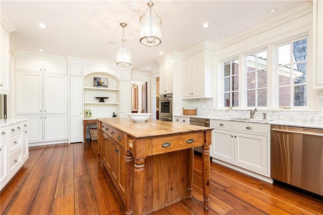 kitchen with dishwasher, white cabinets, dark wood finished floors, and a sink