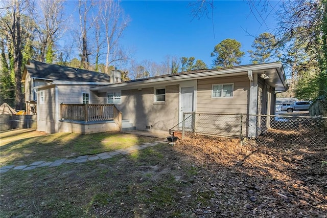 back of house with a deck