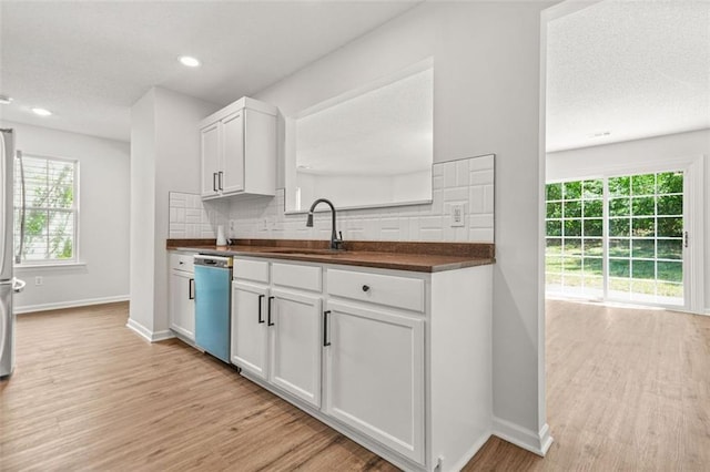 3454 Carriage Chase Rd, Atlanta, GA 30349 - kitchen with dishwasher, a sink, dark countertops, light wood-type flooring, and recessed lighting