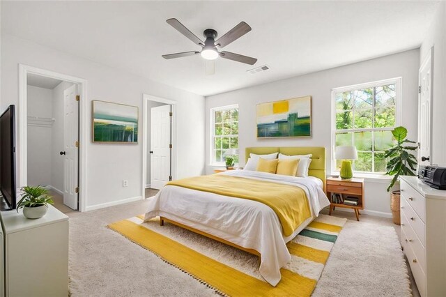3454 Carriage Chase Rd, Atlanta, GA 30349 - bedroom with light colored carpet, baseboards, ceiling fan, and a walk in closet