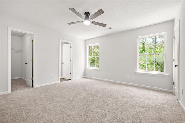 3454 Carriage Chase Rd, Atlanta, GA 30349 - unfurnished bedroom featuring carpet flooring, a spacious closet, a textured ceiling, and baseboards