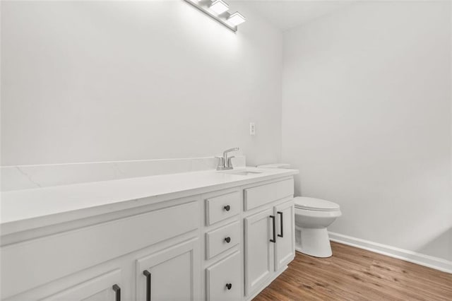 3454 Carriage Chase Rd, Atlanta, GA 30349 - bathroom with toilet, wood finished floors, vanity, and baseboards