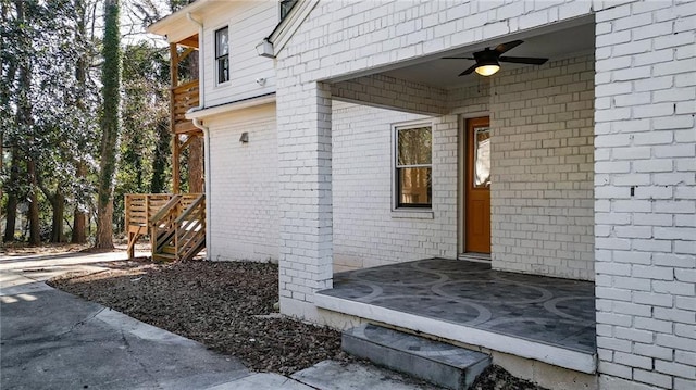 view of exterior entry with ceiling fan