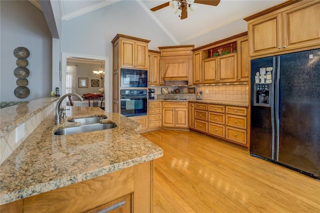 kitchen featuring black appliances, a sink, ceiling fan, backsplash, and light stone countertops