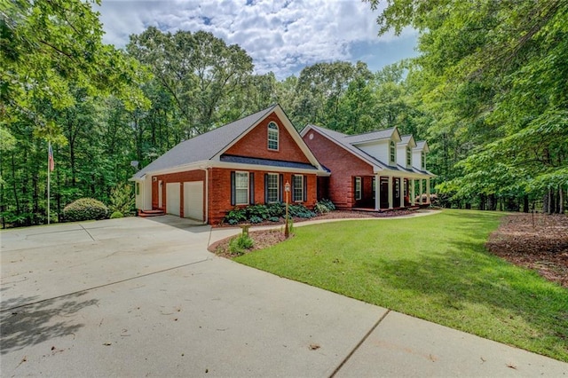 view of front of property with brick siding, driveway, and a front lawn