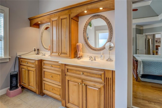 full bathroom featuring double vanity, ensuite bathroom, baseboards, tile patterned flooring, and ornamental molding