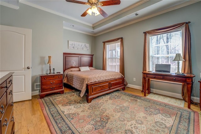 bedroom featuring light wood-style flooring, crown molding, a ceiling fan, and baseboards