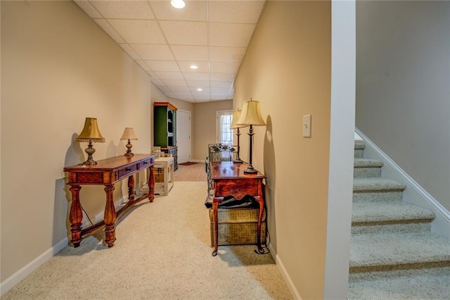 corridor featuring carpet flooring, stairway, recessed lighting, baseboards, and a paneled ceiling