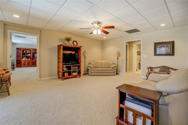 carpeted living area with a drop ceiling, a ceiling fan, baseboards, and recessed lighting