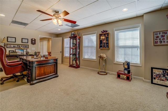 carpeted home office featuring ceiling fan, a paneled ceiling, and baseboards