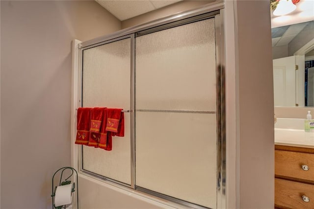 bathroom featuring shower / bath combination with glass door and vanity