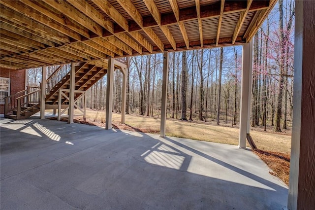 view of patio / terrace featuring stairs and a view of trees