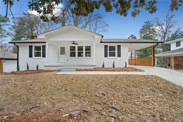 single story home featuring covered porch and a carport