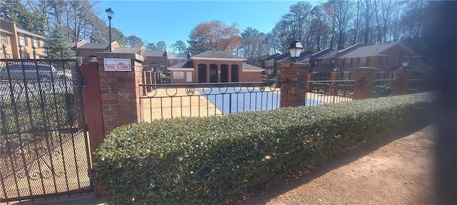 view of pool with a residential view and fence