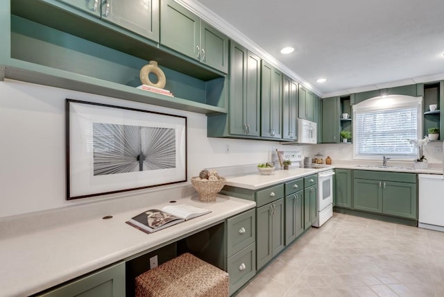 kitchen with green cabinetry, sink, and white appliances