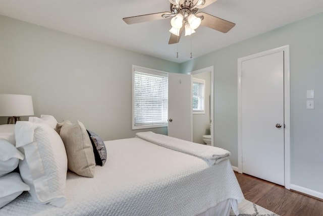 bedroom with ceiling fan, ensuite bathroom, and hardwood / wood-style flooring