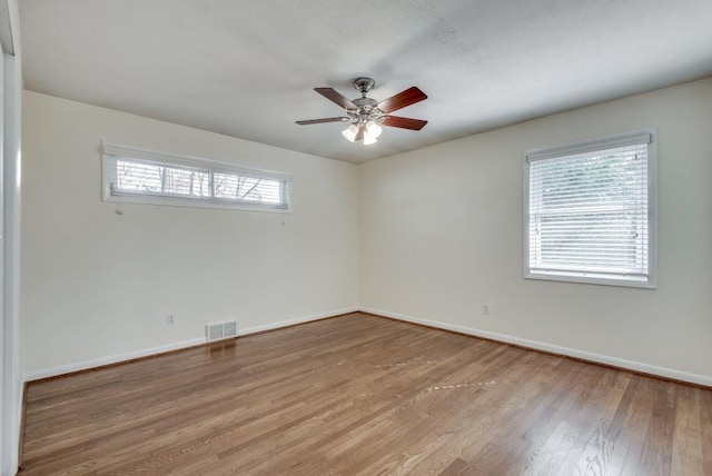 unfurnished room with light wood-type flooring and ceiling fan